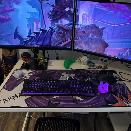 Real customer gaming setup featuring a purple anime-inspired extended mousepad, RGB keyboard, dual monitors, and aesthetic gaming desk accessories.
