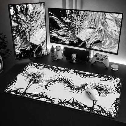 Gothic centipede mouse pad with dark botanical artwork on a black desk setup