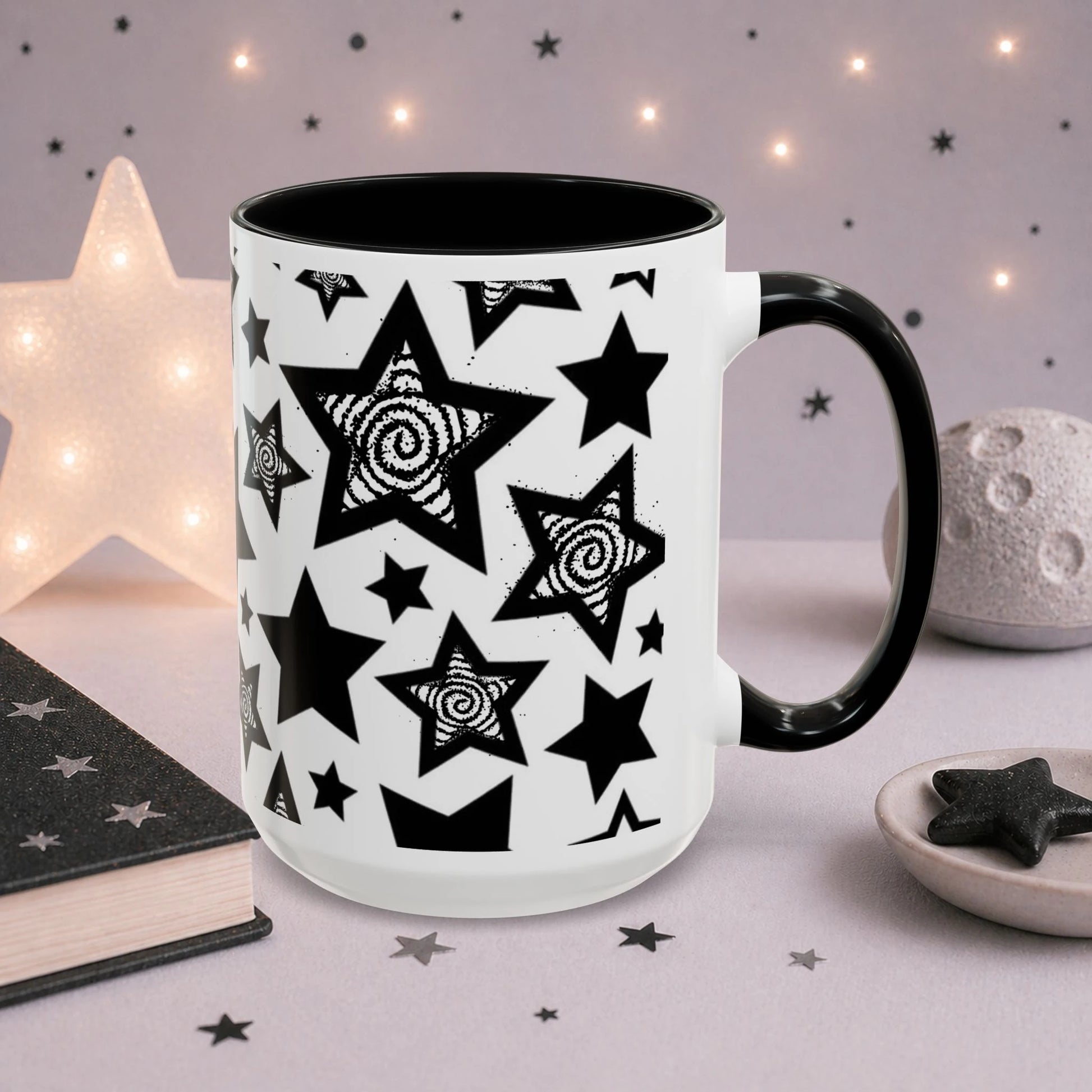 Wraparound black and white star mug showcasing a seamless celestial pattern with bold stars and hypnotic spiral details on white ceramic.