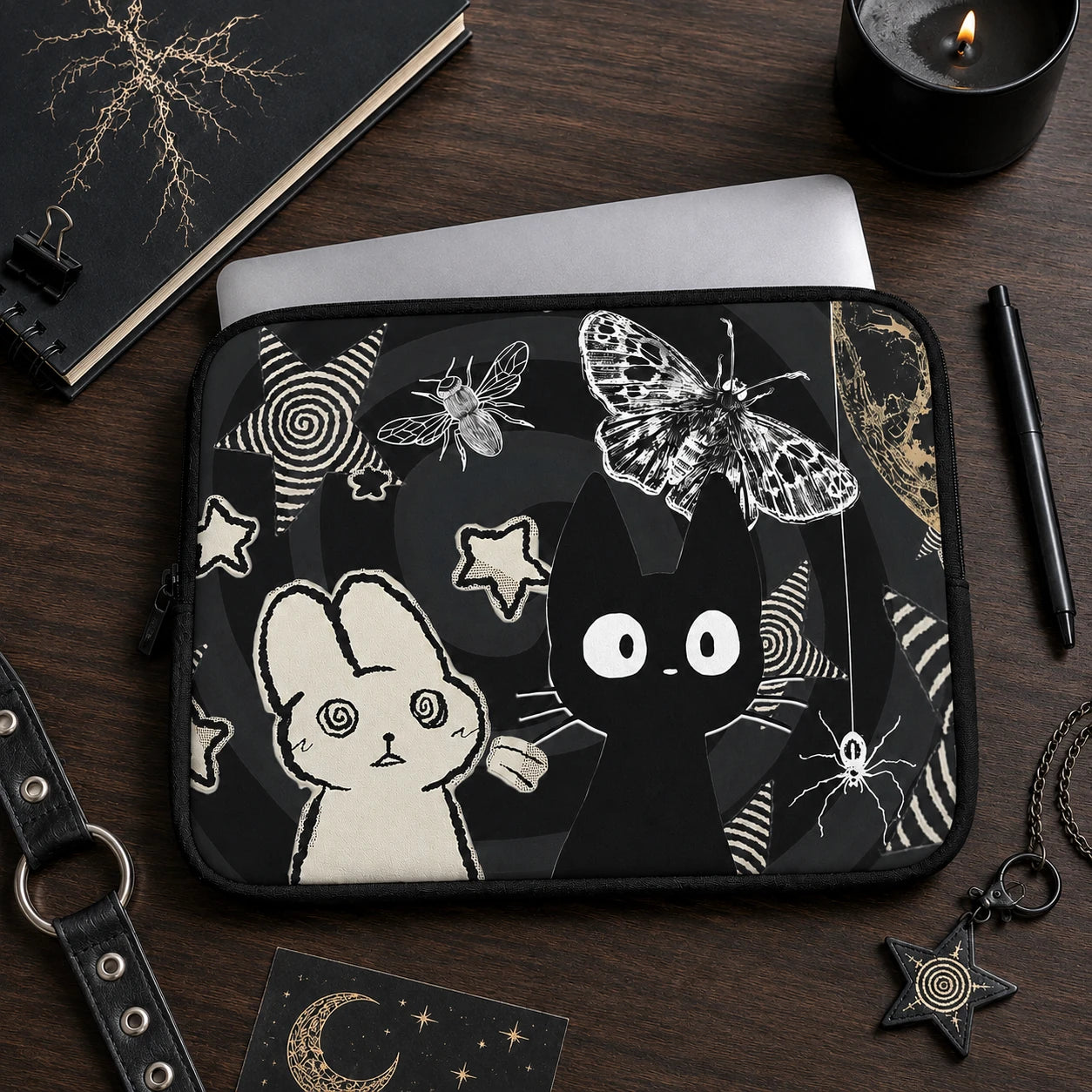 Woman holding a gothic kawaii laptop sleeve featuring black cat, bunny, butterfly and celestial artwork in a dark alternative fashion aesthetic.