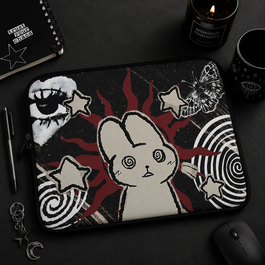 Alternative fashion model holding a gothic laptop sleeve with hypnotic bunny artwork, butterfly illustration, celestial motifs and dark grunge aesthetic.