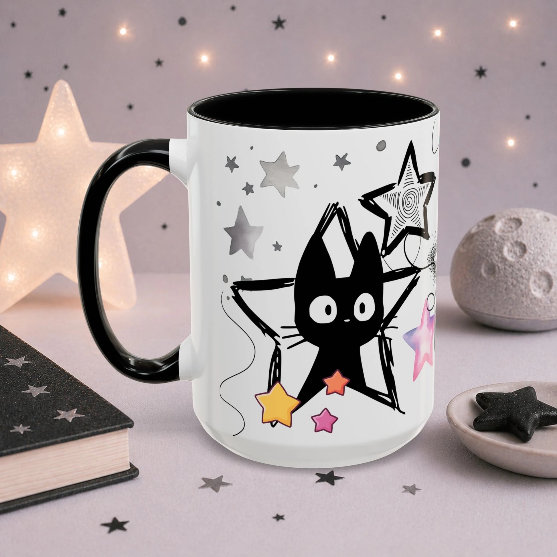 Cute black cat star mug in a cozy celestial decor setting with glowing star lamp, moon ornament and pastel aesthetic background, perfect for coffee and tea lovers.