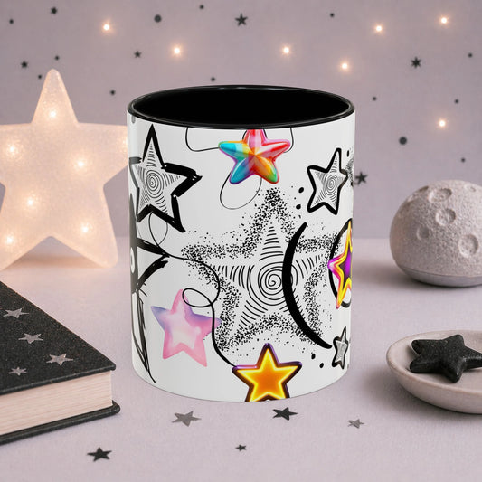 Celestial gothic cat mug featuring colorful holographic stars, black swirl details and dreamy space-inspired artwork, photographed in a cozy aesthetic setting.