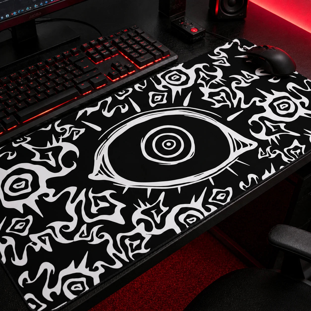 Black gothic gaming mousepad featuring an all-seeing eye design with abstract white tribal patterns, oversized desk mat for dark aesthetic and alternative gaming setups.