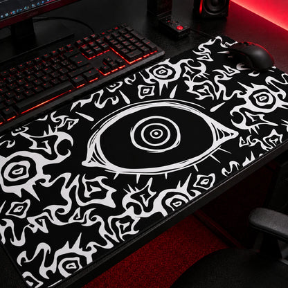 Black gothic gaming mousepad featuring an all-seeing eye design with abstract white tribal patterns, oversized desk mat for dark aesthetic and alternative gaming setups.