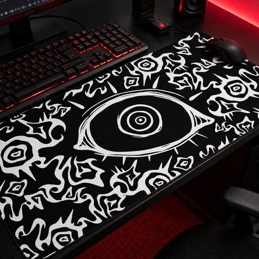 Black gothic gaming mousepad featuring an all-seeing eye design with abstract white tribal patterns, oversized desk mat for dark aesthetic and alternative gaming setups.