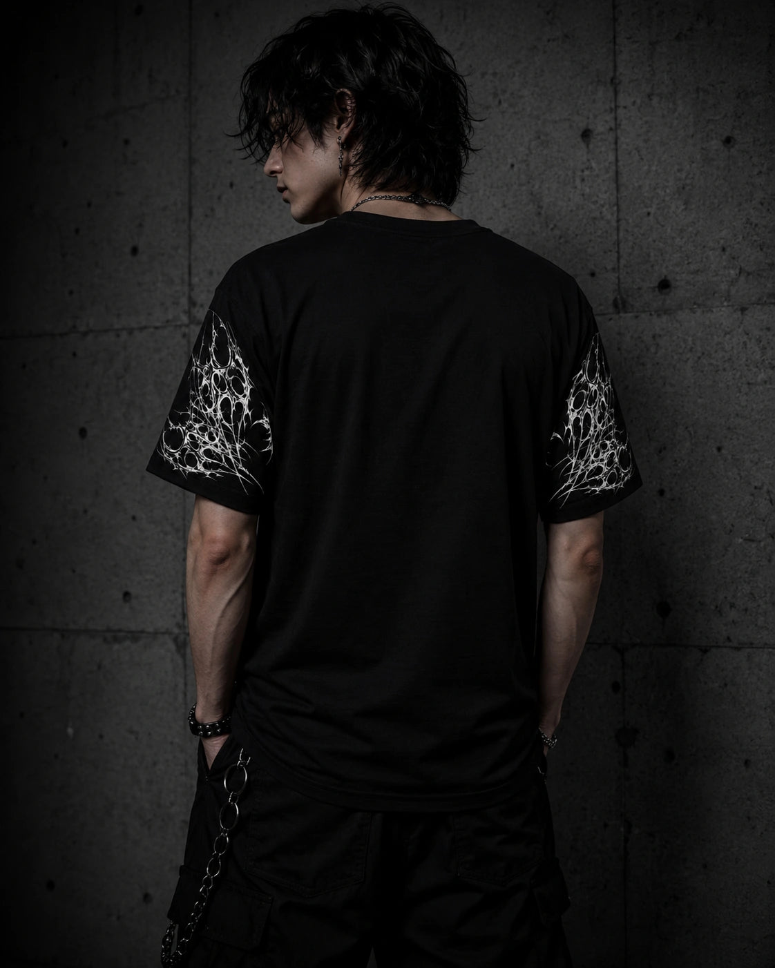 Back view of oversized black gothic butterfly shirt showing sleeve artwork and relaxed unisex fit.