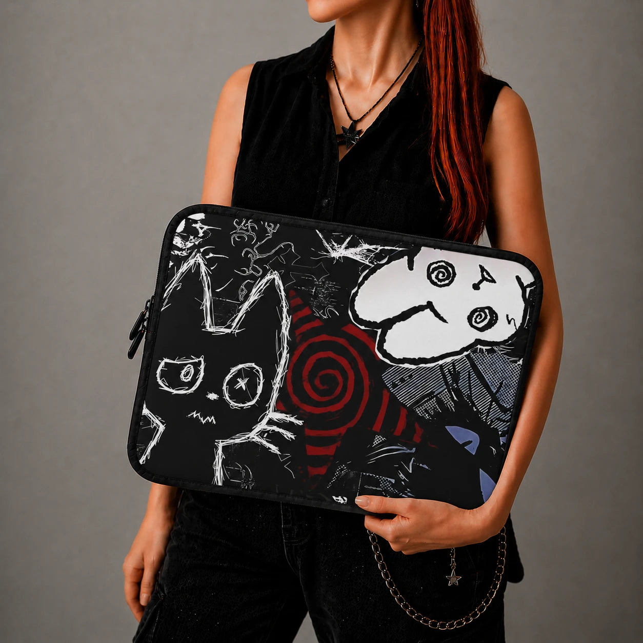 Gothic cat laptop sleeve with dark grunge artwork, black and white spooky cat illustration and alternative aesthetic design, held by woman in black outfit.