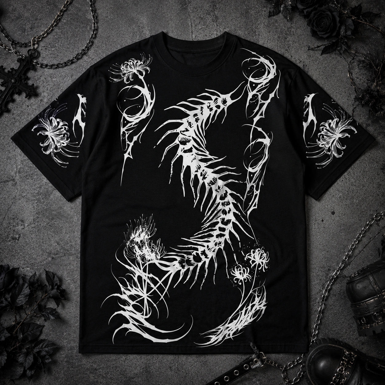Black oversized gothic t-shirt with large white centipede skeleton graphic and spider lily sleeve prints displayed in a dark aesthetic flat lay.