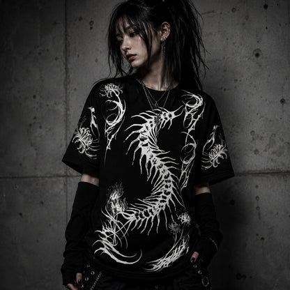 Female model wearing oversized black gothic t-shirt with white centipede skeleton graphic and spider lily artwork in alternative fashion aesthetic.
