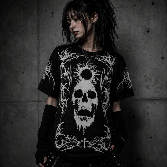 Female model wearing oversized black gothic skull t-shirt featuring white eclipse and occult-inspired graphic in dark alternative fashion style.