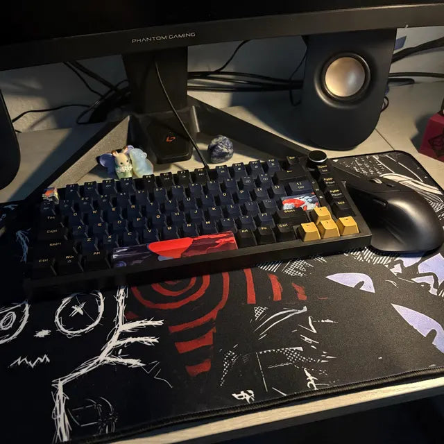 Alternative aesthetic gaming desk setup featuring a dark punk creepy cat mousepad with black, white and red grunge artwork and stitched edges.