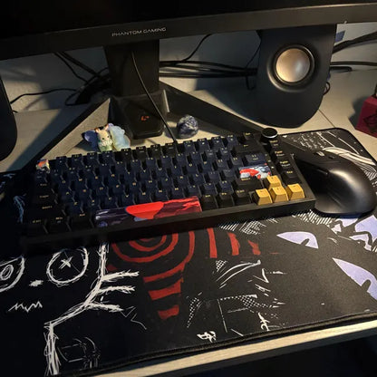 Alternative aesthetic gaming desk setup featuring a dark punk creepy cat mousepad with black, white and red grunge artwork and stitched edges.