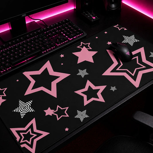 Pink and black aesthetic gaming mousepad featuring pastel pink star patterns and hypnotic spiral star accents on a black background. Large extended desk mat with kawaii, pastel goth, and alternative aesthetic, perfect for cute gaming setups, workstations, and desk decor.
