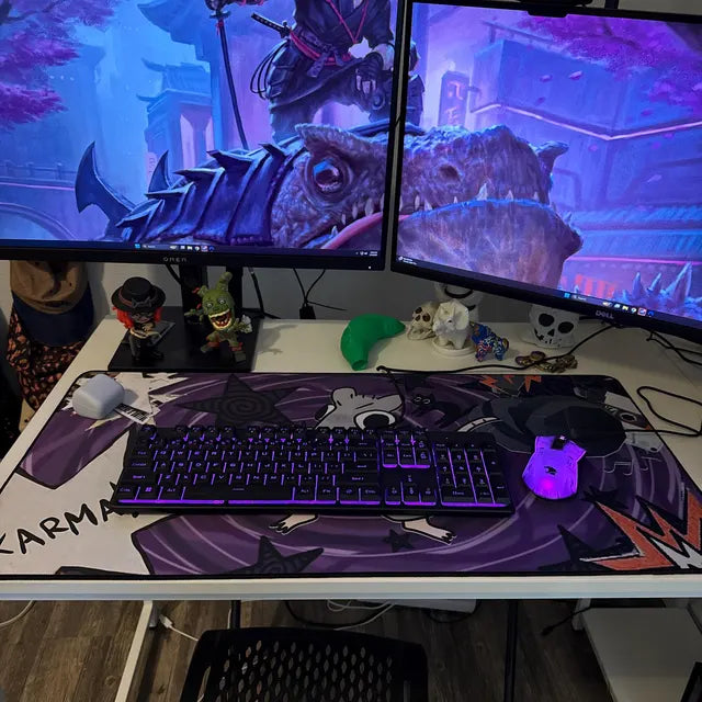 Real customer gaming setup featuring a purple anime-inspired extended mousepad, RGB keyboard, dual monitors, and aesthetic gaming desk accessories.
