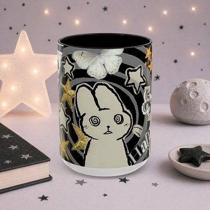 Cute weirdcore mug featuring a spiral-eyed cat character, butterfly illustration, stars and surreal scrapbook collage artwork.