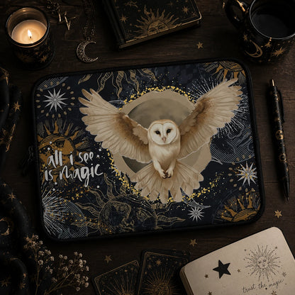 Witchy owl laptop sleeve with celestial moon and sun illustrations, displayed in a dark magical workspace with candles, tarot cards and mystical accessories.
